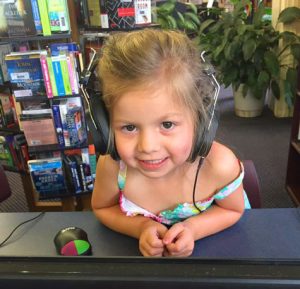 Little girl listening to headphones
